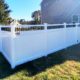 white vinyl privacy fence with black aluminum balsuter topper