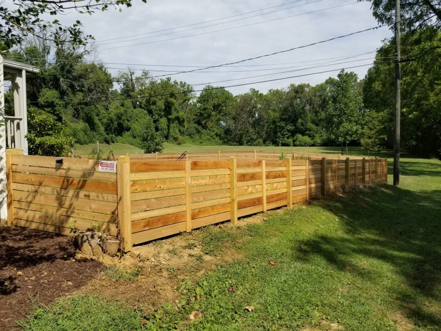 4 foot high Cedar Horizontal Fence with alternating sized boards and dog ear posts