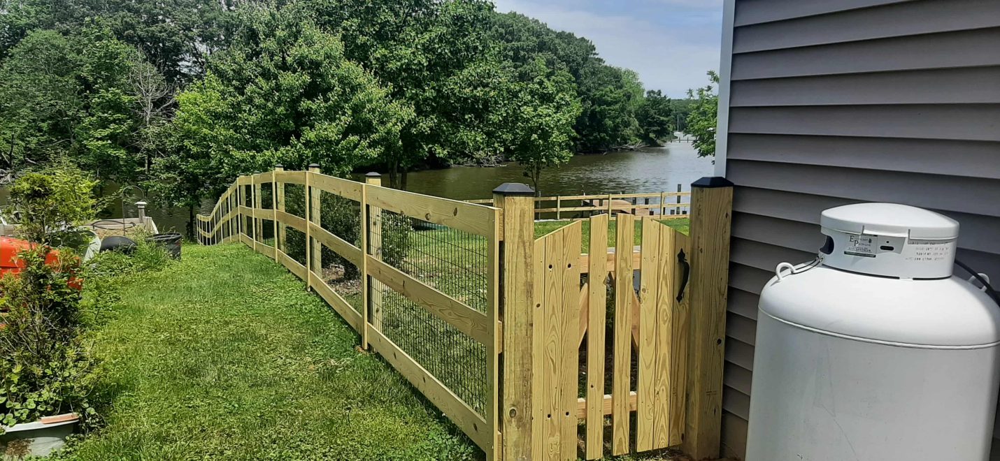 Pressure treated 3-rail ranch rail fence with black mesh and single arched gate (2)-min