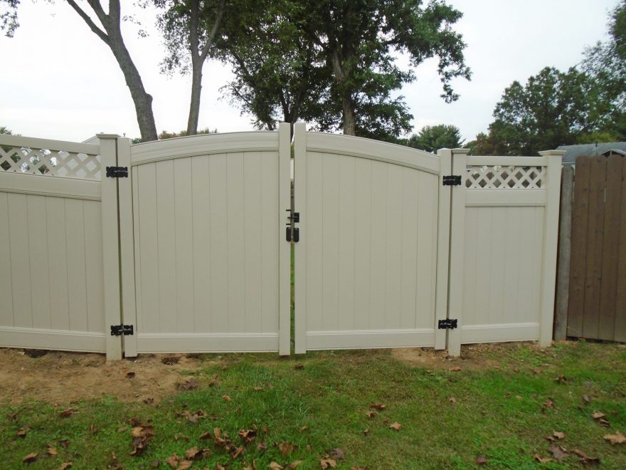 Tan Vinyl Privacy Fencing with Lattice top and double arched gate