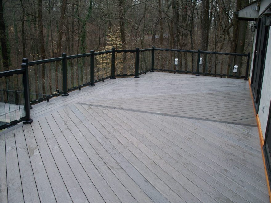 TimberTech Legacy Ashwood Decking installed in Diagonal Pattern with Espresso Feature Board and Black Aluminum Railing with Glass Pickets