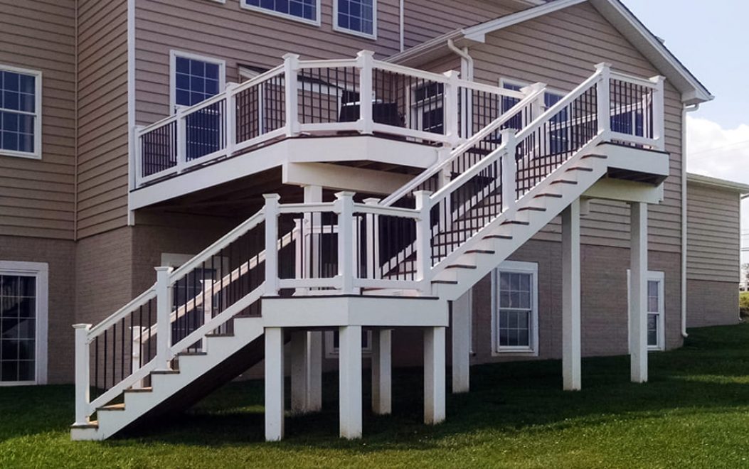 Trex Composite deck & porch with white vinyl railing & black ballusters, facia board and wrapped beams & posts