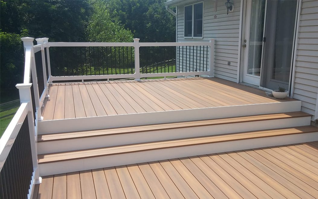 Trex Composite deck with steps and vinyl railing with black aluminum ballusters