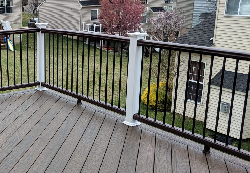 Trex Transcend Spiced Rum Deck Boards in a Diagonal Pattern with Trex composite railing in matching Spiced Rum with white composite posts and black aluminum balusters in Ellicott City MD