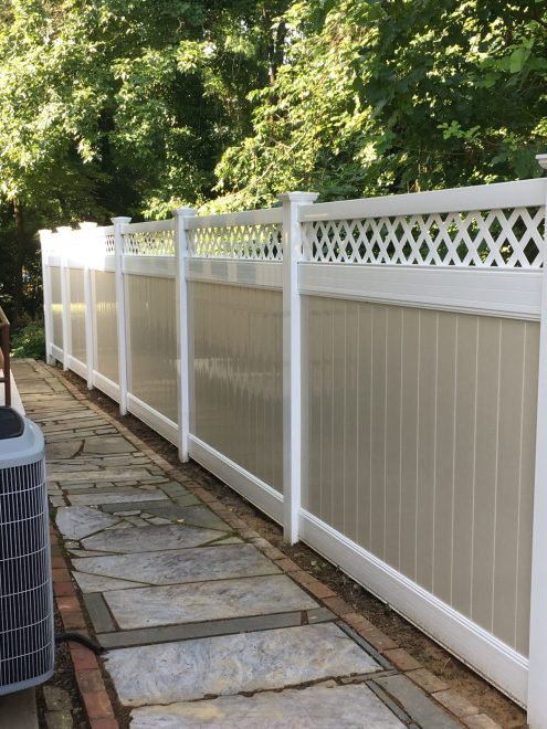 Two toned tan and white vinyl privacy fence with lattice top 2