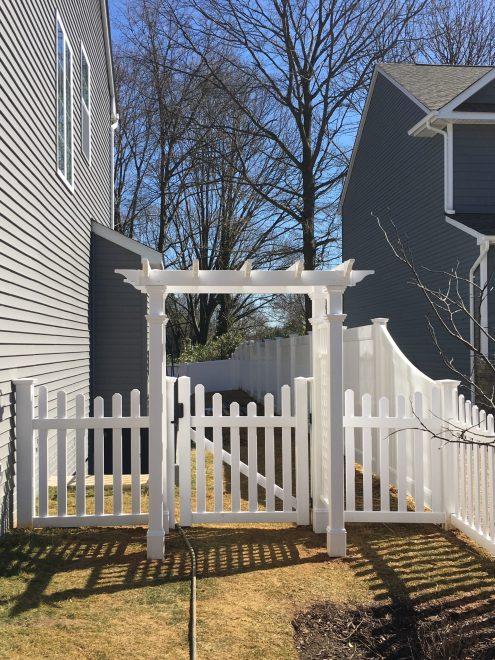 White Vinyl Picket Fence with dip and Arbor walk Gate + 6 foot high Privacy Fence with Transition section between Fence heights